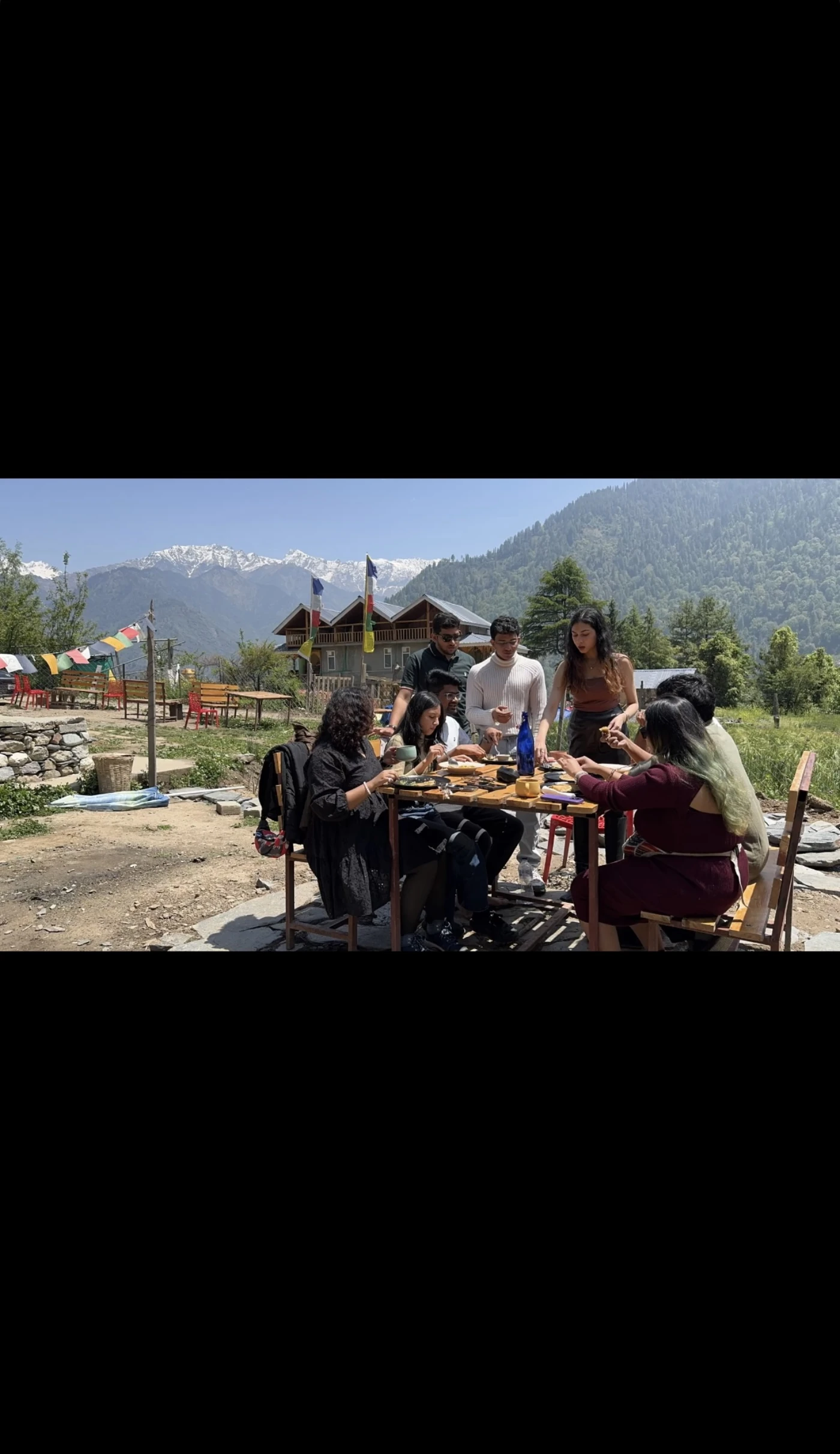 Hands holding chai at sunrise